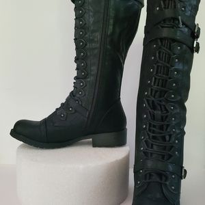 Black faux leather boots.